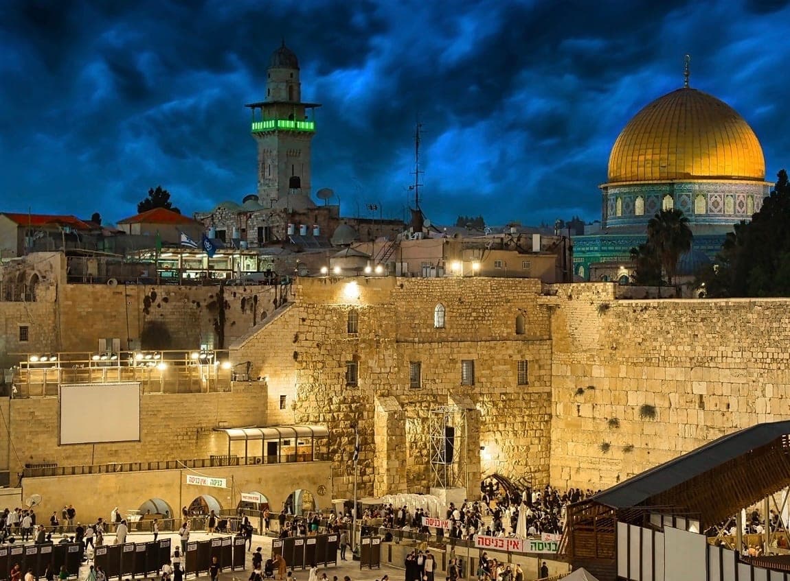 The Western Wall and the golden Dome of the Rock in the Old City of Jerusalem at dusk
