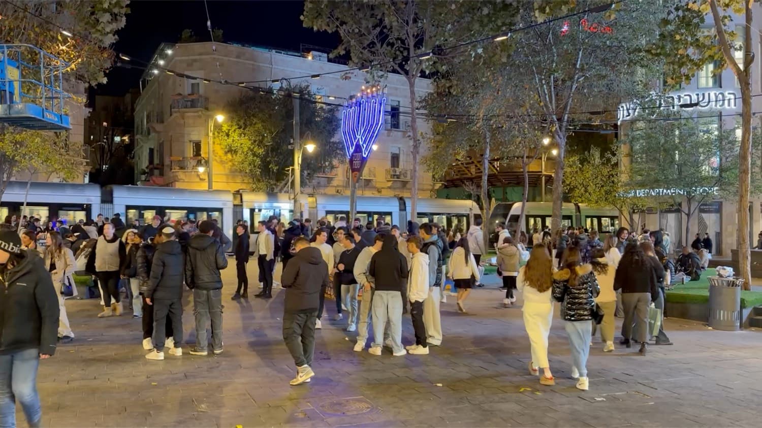 An evening street scene in central Jerusalem during Chanukkah