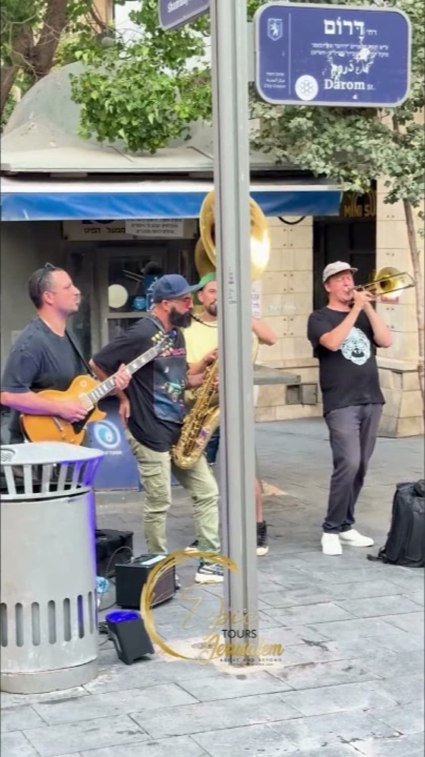 Street musicians playing guitar, saxophone and horns in central Jerusalem