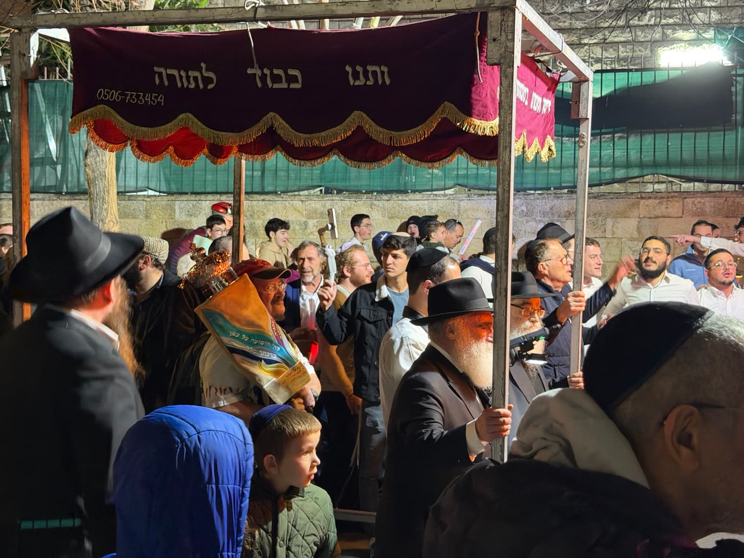 The canopy over a new Torah scroll during the procession