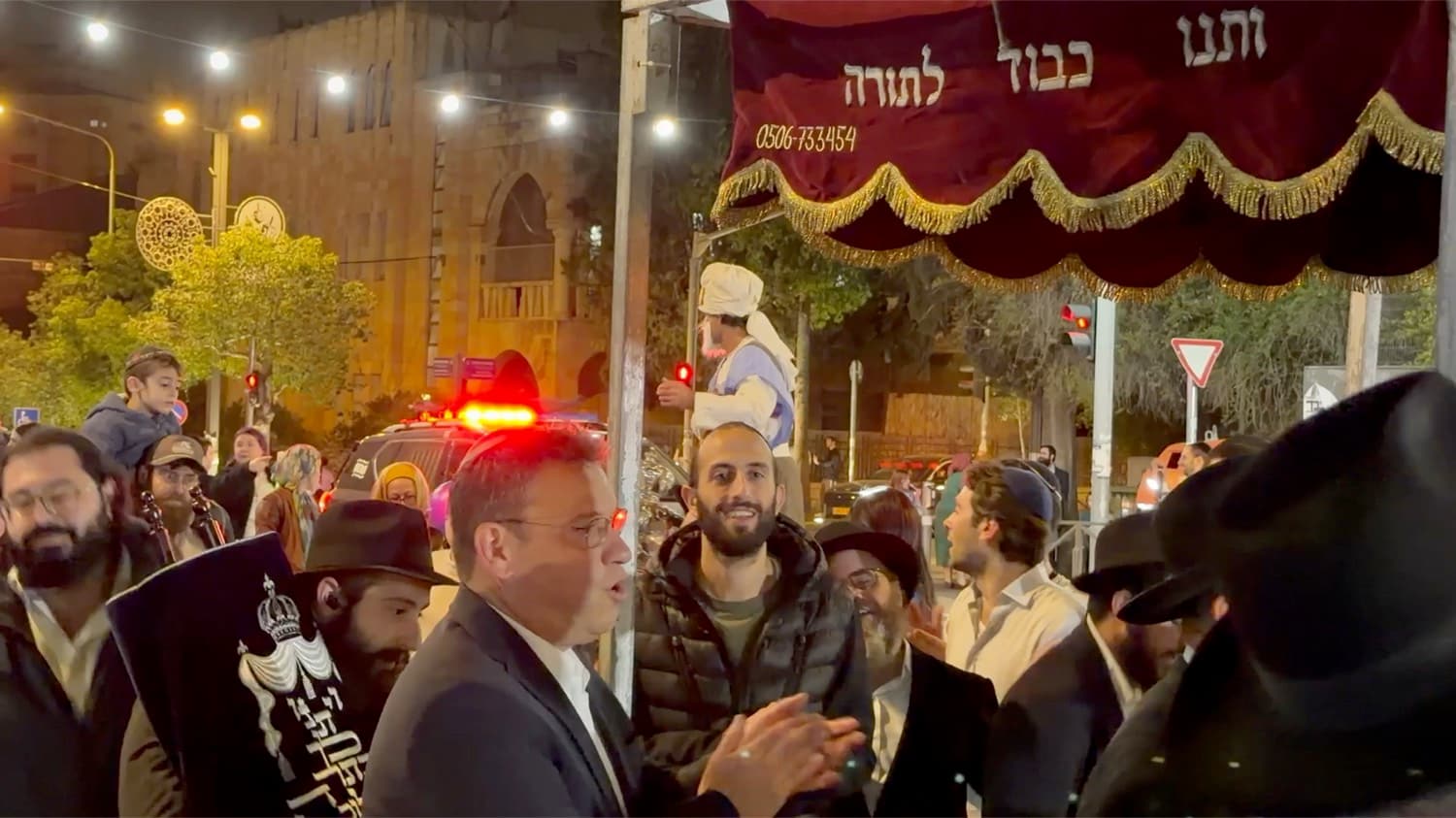The Torah procession moving through the streets of Jerusalem